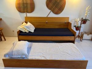 a bed with a wooden frame in a room at Caparica ap vista mar in Costa da Caparica