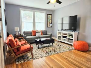 a living room with a couch and a tv at Dundee Escape in Charleston