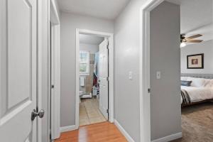 a hallway with a bedroom and a bed and a ceiling fan at Tranquil 2BR Apt Mpls - 8075 Apt 3 in Minneapolis
