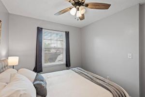 a bedroom with a bed and a ceiling fan at Tranquil 2BR Apt Mpls - 8075 Apt 3 in Minneapolis