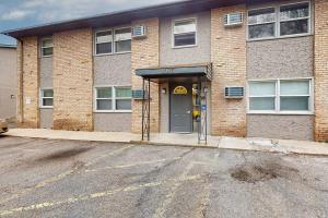 a brick building with a door and a parking meter at Tranquil 2BR Apt Mpls - 8075 Apt 3 in Minneapolis