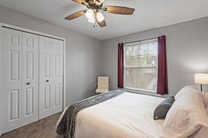 a bedroom with a bed with a ceiling fan and a window at Tranquil 2BR Apt Mpls - 8075 Apt 3 in Minneapolis