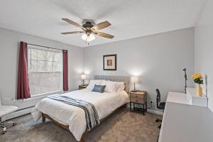a bedroom with a bed and a ceiling fan at Tranquil 2BR Apt Mpls - 8075 Apt 3 in Minneapolis