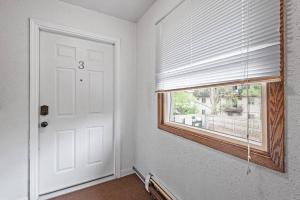 a white room with a window and a white door at Tranquil 2BR Apt Mpls - 8075 Apt 3 in Minneapolis