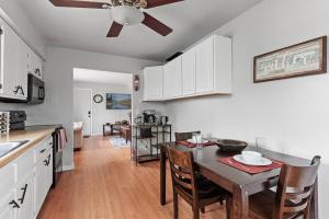 a kitchen and dining room with a table and a ceiling fan at Tranquil 2BR Apt Mpls - 8075 Apt 3 in Minneapolis