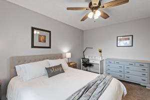 a bedroom with a bed with a ceiling fan and a dresser at Tranquil 2BR Apt Mpls - 8075 Apt 3 in Minneapolis