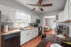 a kitchen with white cabinets and a ceiling fan at Tranquil 2BR Apt Mpls - 8075 Apt 3 in Minneapolis