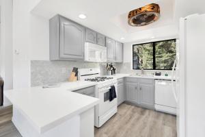 a white kitchen with white appliances and a window at Sunny side up #1343 in Big Bear Lake