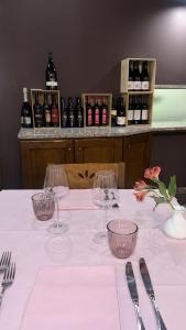 una mesa con copas de vino encima en Da Noi Trattoria Hotel, en Vergato