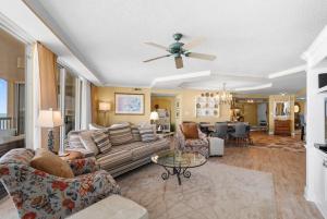 a living room with a couch and a ceiling fan at Coastal Paradise Getaway 3BR Condo Ocean View in Pawleys Island