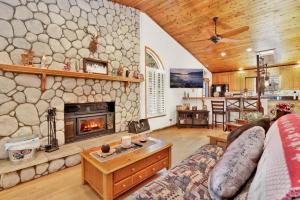 sala de estar con pared de piedra y chimenea en Beardise #2329 en Big Bear City