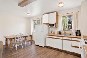 cocina con mesa y nevera blanca en Twin pines #111, en Big Bear Lake