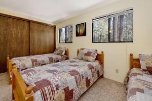 a bedroom with two beds and two windows at Midnight howl #1536 in Big Bear Lake