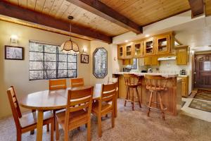 a kitchen and dining room with a wooden table and chairs at Midnight howl #1536 in Big Bear Lake