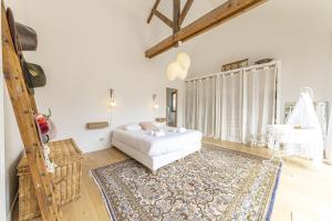 מיטה או מיטות בחדר ב-La Familia - Maison chaleureuse