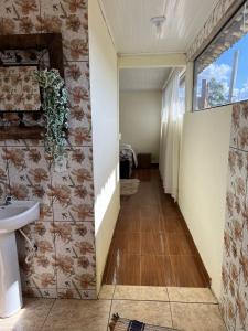 a hallway of a bathroom with a sink at Pouso de Teria in Tiradentes +3 photos