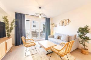 a living room with a couch and chairs at La Kloserie appartement en résidence in Saint Malo