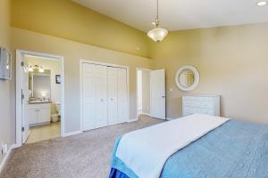 a bedroom with a bed and a bathroom with a mirror at Beach Escape in Rockaway Beach +14 photos