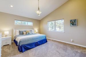 a bedroom with a bed and two windows at Beach Escape in Rockaway Beach