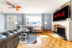 a living room with a couch and a fireplace at Comfy Getaway - Walk to West Ed Mall in Edmonton
