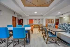 a classroom with tables and blue chairs at Holiday Inn Express Hotel & Suites Portland - Jantzen Beach, an IHG Hotel in Portland