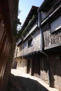 an old building with a wooden balcony on it at La Casa del Burro in La Alberca