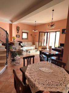 a living room with a table and a couch at B&B Il Girasole in Castel di Sangro