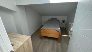 a small bedroom with a small bed in a small room at Les Vallées in Thonon-les-Bains
