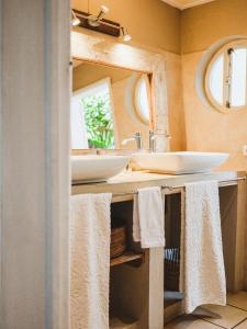 a bathroom with a sink and a mirror and towels at Harmonie in Rivière Noire