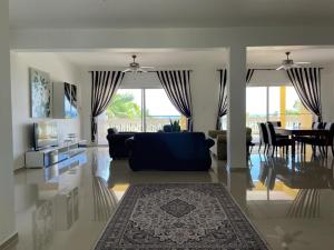 a living room with a couch and a dining room at Spring Garden Mobay Resort in Montego Bay