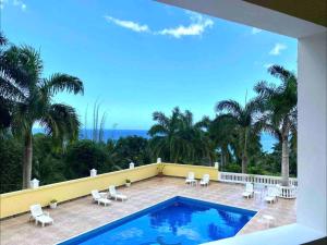 a view of a swimming pool from a house at Spring Garden by Mel in Montego Bay