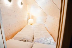 a room with two beds in a small room at Chalet Lepenatka with Sauna - I feel Alps in Stahovica