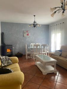 a living room with a couch and a table at CASA EL RÍO in Trevélez