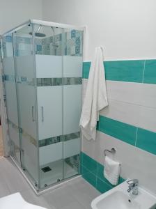 a bathroom with a glass shower and a sink at MareFuori in Giardini Naxos +22 photos