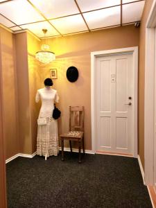 a dress on a mannequin in a hallway at Guesthouse 'Blue House' in vintage villa&garden in Copenhagen