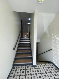 a staircase in a building with a black and white tile floor at Cathedral 6-Walk to UNMC in Omaha