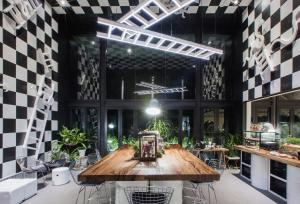 a room with a wooden table and chairs in it at Blu Monkey Hub and Hotel Phuket Town- Free All Day Coworking space in Phuket Town