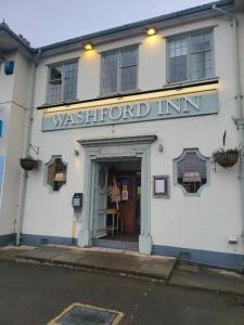 a building with the entrance to a west end inn at The Washford Station Inn, in Washford