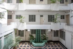 an external view of a building with palm trees at Edificio Art Deco en Roma Norte in Mexico City