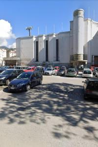 a parking lot with cars parked in front of a factory at Luxury house Le mie peonie in Salerno