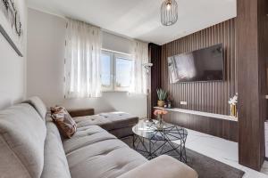a living room with a couch and a tv at Summer Dream Apartment in Sveti Filip i Jakov