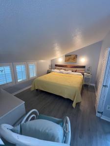 ein Schlafzimmer mit einem gelben Bett und einem Stuhl in der Unterkunft Isle Be Back in Destin