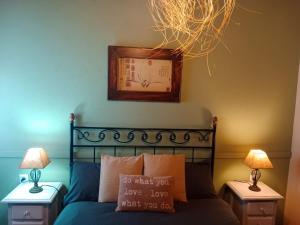 a bedroom with a blue bed with two night stands at Huerta Del Pasil (Casa Entera) in Córdoba +31 photos