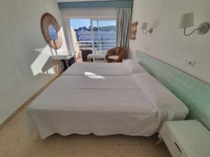 Postel nebo postele na pokoji v ubytování Hostal Roberto