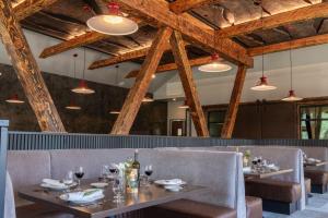 a dining room with tables and chairs and wooden ceilings at Firefall Ranch Yosemite in Groveland