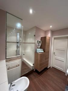 a bathroom with a shower and a sink and a tub at Albert-Schulte-Park Apartment- Worms in Worms
