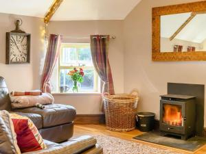 a living room with a couch and a stove at 2 Bed in Crickhowell 90346 in Crickhowell