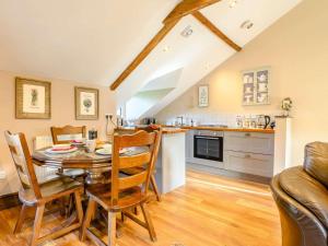 a kitchen and dining room with a table and chairs at 2 Bed in Crickhowell 90346 in Crickhowell