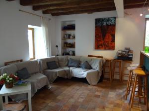 a living room with a couch and a table at Au Moulin Géant in Rochefort-sur-Loire