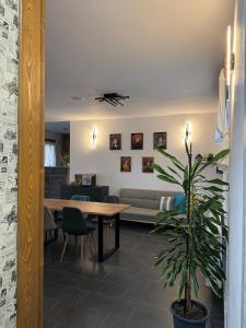 a living room with a table and a couch at Constantin Panzió in Praid